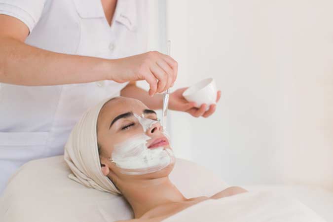 Young lady applying mask for lady face